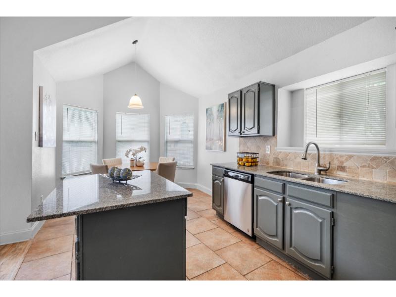 Kitchen with granite countertops and breakfast nook at 1115 Cherrytree Drive Arlington TX