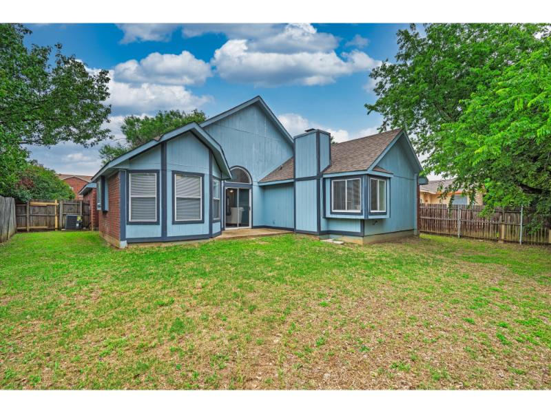 Fenced backyard with concrete patio at 1115 Cherrytree Drive Arlington TX